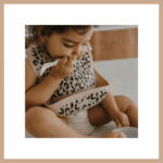 Selection of kids' gifts in Geneva toy stores. Leopard print bib, stylish kids' Christmas gift Geneva